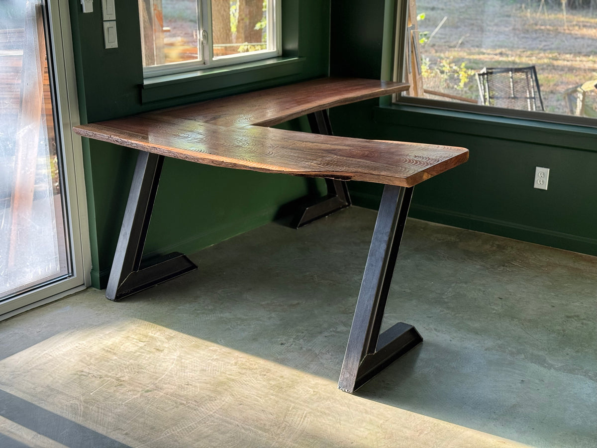 Custom live-edge walnut L-shaped desk on welded steel Z-legs, built by Prestigious Metal Works, Waco TX